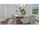 Dining room with hardwood floors, large windows and a wooden table at 3024 W Cass St, Tampa, FL 33609