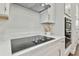 Modern kitchen with white cabinets and cooktop at 3024 W Cass St, Tampa, FL 33609