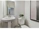 Clean powder room, featuring a pedestal sink and toilet at 3024 W Cass St, Tampa, FL 33609