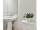 Modern powder room with pedestal sink and toilet at 3024 W Cass St, Tampa, FL 33609