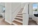 Modern staircase with wood steps and white railings at 3024 W Cass St, Tampa, FL 33609