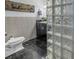 Modern bathroom with glass block shower and dark vanity at 314 33Rd Ne Ave, St Petersburg, FL 33704