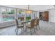 Bright dining room with glass table and seating for six, overlooking pool at 314 33Rd Ne Ave, St Petersburg, FL 33704
