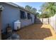 Landscaped side yard with gravel and a propane tank at 314 33Rd Ne Ave, St Petersburg, FL 33704