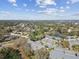 Aerial view of a residential area, showcasing condos with mature landscaping in a community near a lake at 3151 Landmark Dr # 123, Clearwater, FL 33761