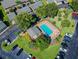 An aerial view showcases the complex's pool surrounded by ample parking at 3151 Landmark Dr # 123, Clearwater, FL 33761