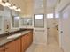 Bathroom features a double vanity, walk-in shower, and tile flooring at 335 Siena Vista Pl, Sun City Center, FL 33573