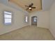 Main bedroom with tray ceiling, ceiling fan and large windows at 335 Siena Vista Pl, Sun City Center, FL 33573