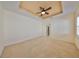 Main bedroom with tray ceiling, ceiling fan and access to bathroom at 335 Siena Vista Pl, Sun City Center, FL 33573