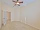 Spacious bedroom with ceiling fan and door to exterior at 335 Siena Vista Pl, Sun City Center, FL 33573