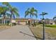 Tan one-story house with palm trees and landscaped yard at 335 Siena Vista Pl, Sun City Center, FL 33573