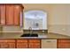 Kitchen features granite countertops and double sink at 335 Siena Vista Pl, Sun City Center, FL 33573