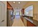 Open concept kitchen with stainless steel appliances and view to backyard at 335 Siena Vista Pl, Sun City Center, FL 33573