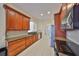 Clean kitchen featuring wood cabinets, granite countertops and stainless steel appliances at 335 Siena Vista Pl, Sun City Center, FL 33573