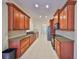 Modern kitchen featuring wood cabinets, granite countertops, and stainless steel appliances at 335 Siena Vista Pl, Sun City Center, FL 33573
