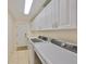 Laundry room with washer, dryer, and ample cabinets at 335 Siena Vista Pl, Sun City Center, FL 33573