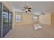 Sunlit living room with sliding glass doors and neutral color palette at 335 Siena Vista Pl, Sun City Center, FL 33573