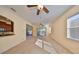 Spacious living room featuring neutral walls, carpeting, and multiple ceiling fans at 335 Siena Vista Pl, Sun City Center, FL 33573