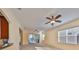 Bright living room with high ceilings, ceiling fans, and sliding glass doors leading to a patio at 335 Siena Vista Pl, Sun City Center, FL 33573