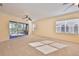 Living room with sliding glass doors, neutral walls and ceiling fan at 335 Siena Vista Pl, Sun City Center, FL 33573