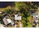 Aerial view of a home with mature landscape near a pond at 346 80Th Ne Ave, St Petersburg, FL 33702