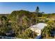 Aerial view of a home with mature trees overlooking a beautiful golf course at 346 80Th Ne Ave, St Petersburg, FL 33702