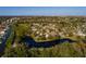 Tranquil waterfront property with a peaceful pond, surrounded by lush greenery and mature trees at 346 80Th Ne Ave, St Petersburg, FL 33702