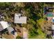Aerial view of home with mature trees and a carport in a lush neighborhood at 346 80Th Ne Ave, St Petersburg, FL 33702