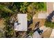 Aerial view of home with gray roof surrounded by green landscaping at 346 80Th Ne Ave, St Petersburg, FL 33702