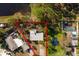 Aerial view of a home with a swimming pool and mature landscape in Rio Vista Park at 346 80Th Ne Ave, St Petersburg, FL 33702