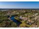 Beautiful waterfront lot with a tranquil pond, surrounded by lush greenery and mature trees at 346 80Th Ne Ave, St Petersburg, FL 33702