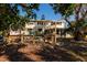 Home exterior with backyard deck that extends toward the lush surrounding foliage, with a glimpse of the tranquil water at 346 80Th Ne Ave, St Petersburg, FL 33702