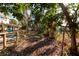 View of the home's backyard, with a deck extending into the green space that borders a serene canal at 346 80Th Ne Ave, St Petersburg, FL 33702