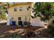 View of the home's side, featuring practical elements like AC units and a fenced area for privacy and utility at 346 80Th Ne Ave, St Petersburg, FL 33702