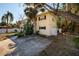 The property's side view, highlighting the two-story structure, window shutters, and verdant surroundings at 346 80Th Ne Ave, St Petersburg, FL 33702