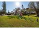 Front yard featuring a lush green lawn, mature trees, and a park sign at 346 80Th Ne Ave, St Petersburg, FL 33702