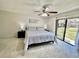 Bedroom featuring a bed, dressers, nightstands, and a sliding glass door leading to outdoor views at 3505 Tarpon Woods Blvd # O405, Palm Harbor, FL 34685