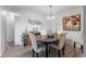 Charming dining room with dark wood table and six light-beige chairs at 3824 37Th S St # 67, St Petersburg, FL 33711