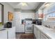 White kitchen with gray backsplash and appliances at 3824 37Th S St # 67, St Petersburg, FL 33711
