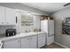 Bright kitchen features granite countertops, white cabinets, and modern appliances at 3824 37Th S St # 67, St Petersburg, FL 33711