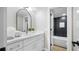 White vanity in modern bathroom with black tiled shower in the background at 4402 Meadowwood Way, Tampa, FL 33618