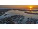 Aerial view of the waterfront community at sunset, featuring stunning water views and neighborhood charm at 4523 Clearwater Harbor S Dr, Largo, FL 33770