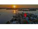 Aerial view of the property showcasing the waterfront community during a gorgeous sunset at 4523 Clearwater Harbor S Dr, Largo, FL 33770