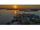 Breathtaking aerial view of the property, surrounded by water and bathed in the golden light of sunset at 4523 Clearwater Harbor S Dr, Largo, FL 33770