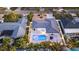 Stunning aerial view of the property showcasing the pool, patio, and manicured landscaping at 4523 Clearwater Harbor S Dr, Largo, FL 33770