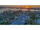 Aerial view of the property with a beautiful sunset reflecting off the water at 4523 Clearwater Harbor S Dr, Largo, FL 33770