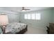 Bright bedroom with light green walls, white window shutters, and a ceiling fan above a comfy bed at 4523 Clearwater Harbor S Dr, Largo, FL 33770