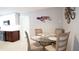 Charming dining area featuring a glass table with seating for four, accented by a unique turtle wall decor at 4523 Clearwater Harbor S Dr, Largo, FL 33770
