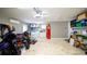 Garage featuring epoxy floors and a practical laundry area, adding functionality and convenience to the space at 4523 Clearwater Harbor S Dr, Largo, FL 33770