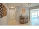 Bright hallway with stylish decor and a bar area, leading to a sunroom and offering a glimpse of the pool at 4523 Clearwater Harbor S Dr, Largo, FL 33770